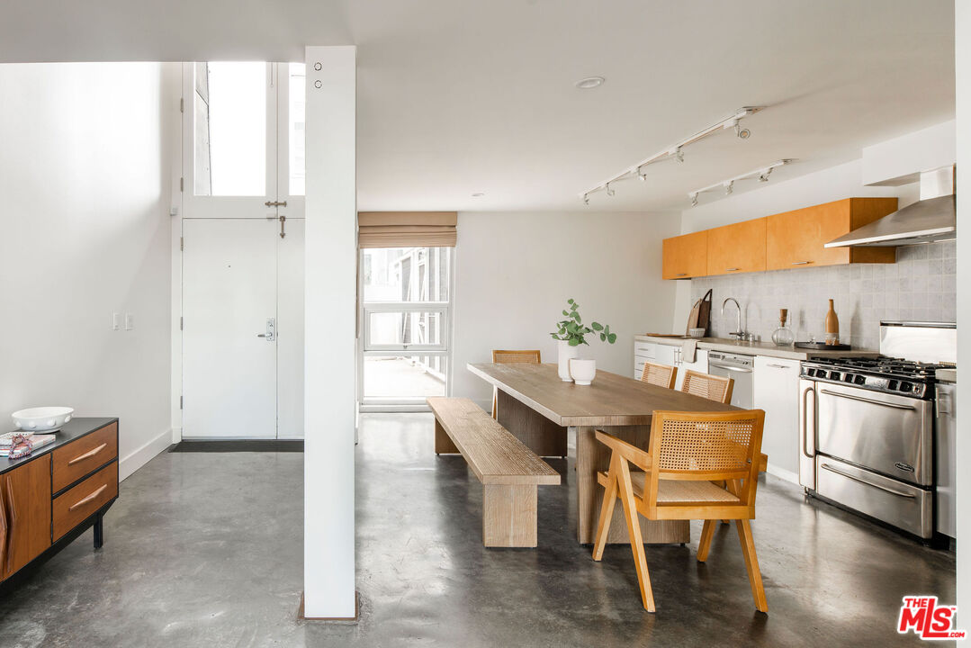 615 Hampton Drive, Unit A101 Venice, CA 90291 - Photo 6 of 24 a dining room with furniture and window