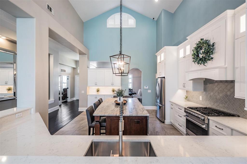 2730 Manning Drive Trinity, FL 34655 - Photo 11 of 43 a living room with furniture a chandelier and kitchen view