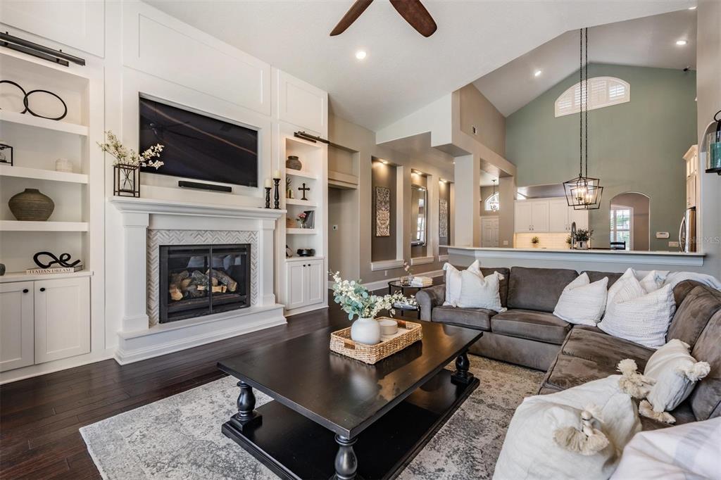 2730 Manning Drive Trinity, FL 34655 - Photo 14 of 43 a living room with furniture a fireplace and a flat screen tv