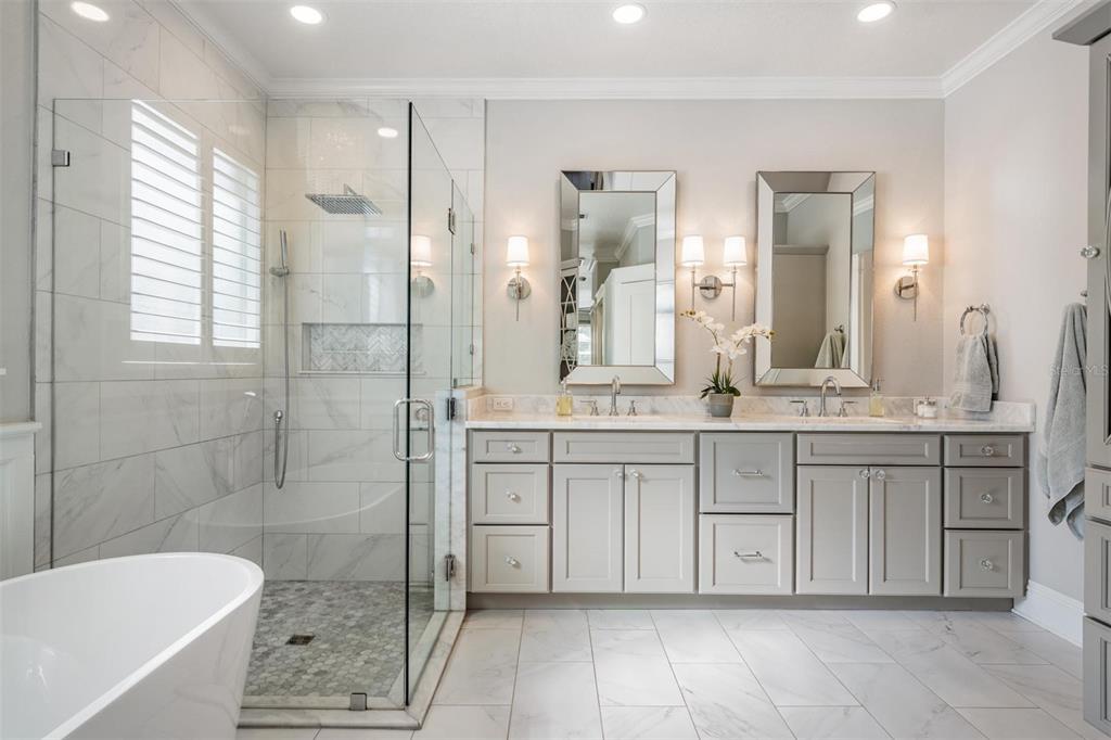 2730 Manning Drive Trinity, FL 34655 - Photo 19 of 43 a spacious bathroom with a granite countertop sink a toilet a mirror and shower