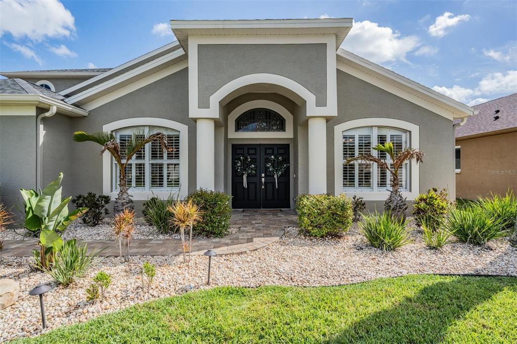 2730 Manning Drive Trinity, FL 34655 - Photo 2 of 43 a front view of a house with garden