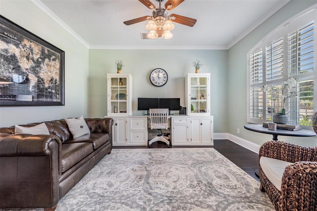 2730 Manning Drive Trinity, FL 34655 - Photo 21 of 43 a living room with furniture a large window and a clock