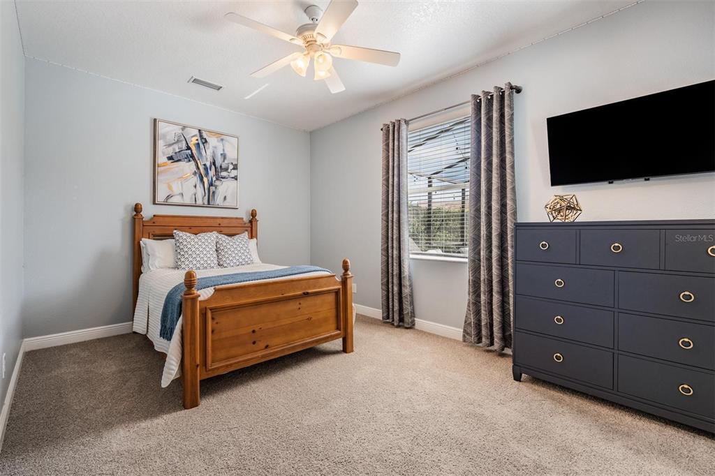 2730 Manning Drive Trinity, FL 34655 - Photo 25 of 43 a bedroom with a bed and a flat screen tv