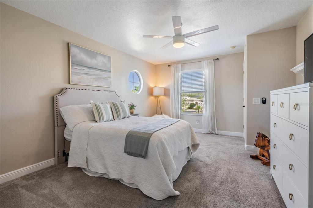 2730 Manning Drive Trinity, FL 34655 - Photo 28 of 43 a bedroom with a bed and a chandelier