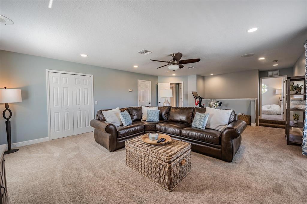 2730 Manning Drive Trinity, FL 34655 - Photo 32 of 43 a living room with furniture a ceiling fan and a window