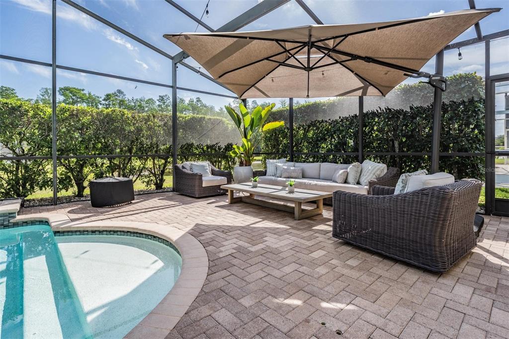 2730 Manning Drive Trinity, FL 34655 - Photo 7 of 43 a view of a patio with couches and chairs under an umbrella