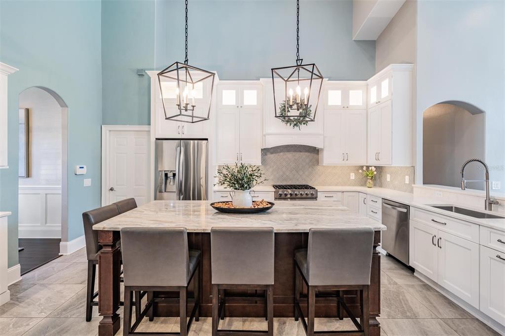 2730 Manning Drive Trinity, FL 34655 - Photo 8 of 43 a dining room with wooden floor a chandelier a wooden table and chairs