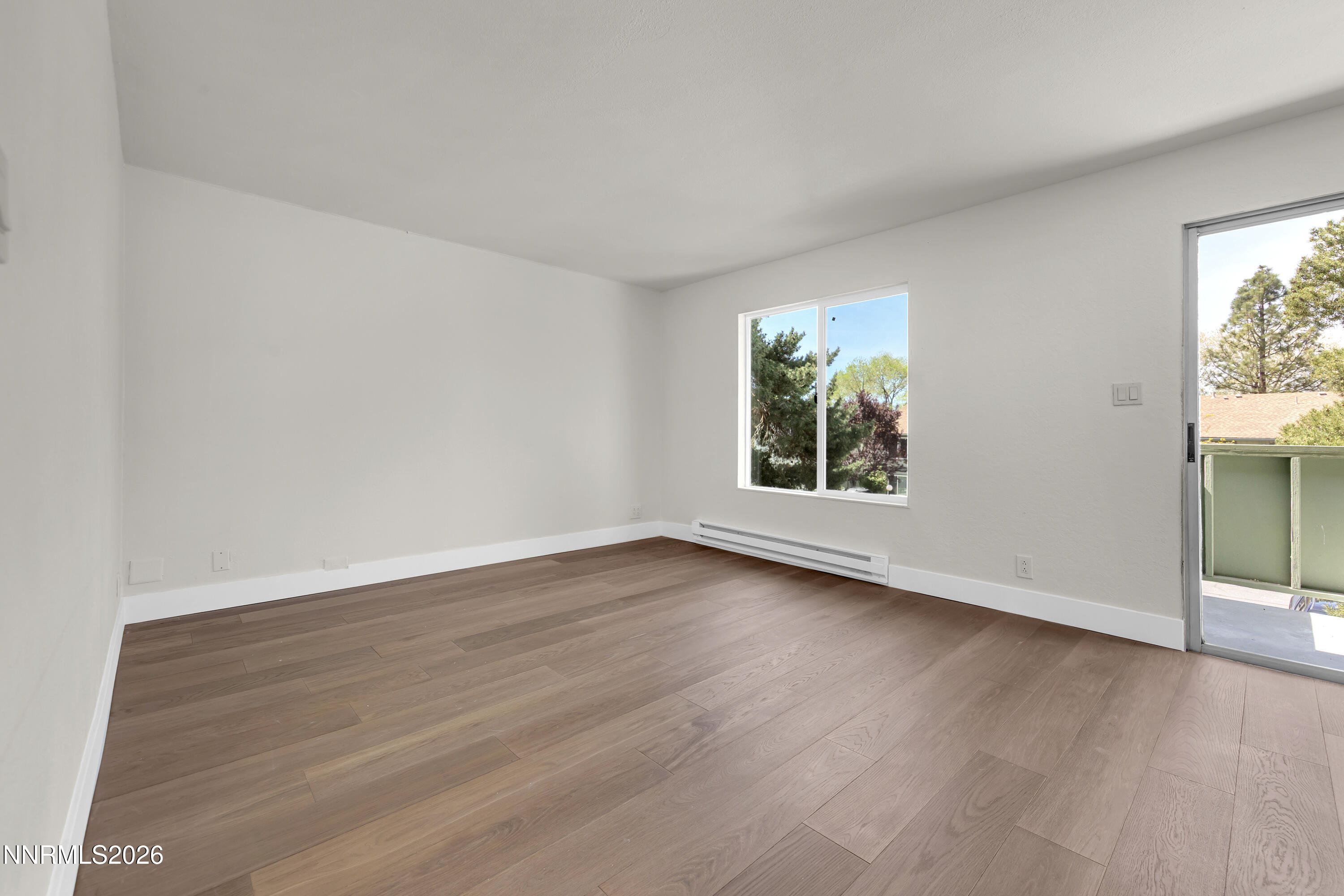 3905 Clear Acre Lane, Unit 26 Reno, NV 89512 - Photo 11 of 27 a view of an empty room with wooden floor and a window
