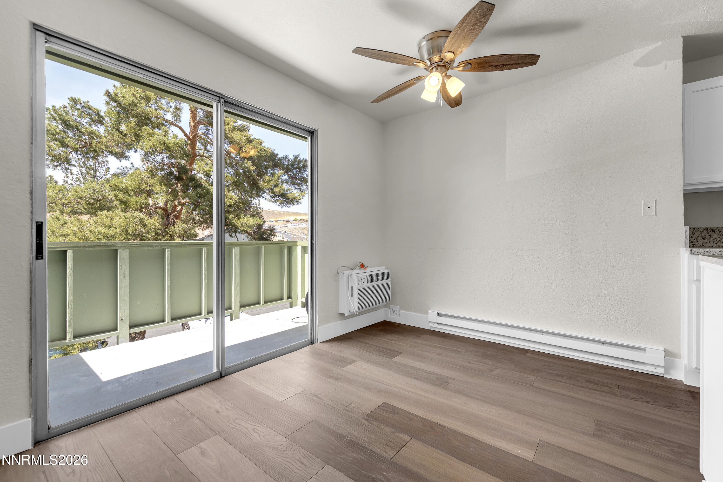 3905 Clear Acre Lane, Unit 26 Reno, NV 89512 - Photo 12 of 27 wooden floor in an empty room with a window