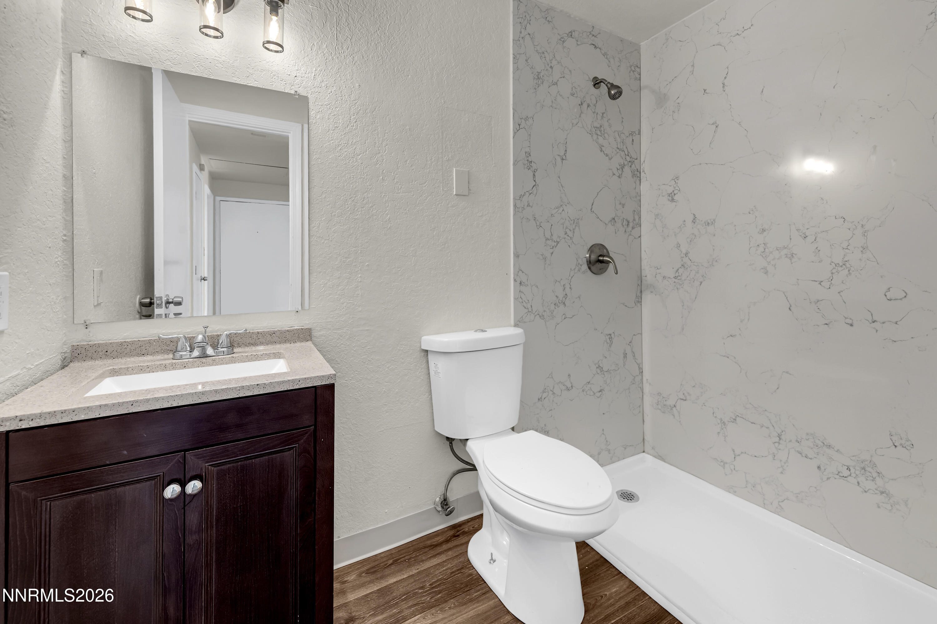 3905 Clear Acre Lane, Unit 26 Reno, NV 89512 - Photo 15 of 27 a bathroom with a sink a toilet and shower