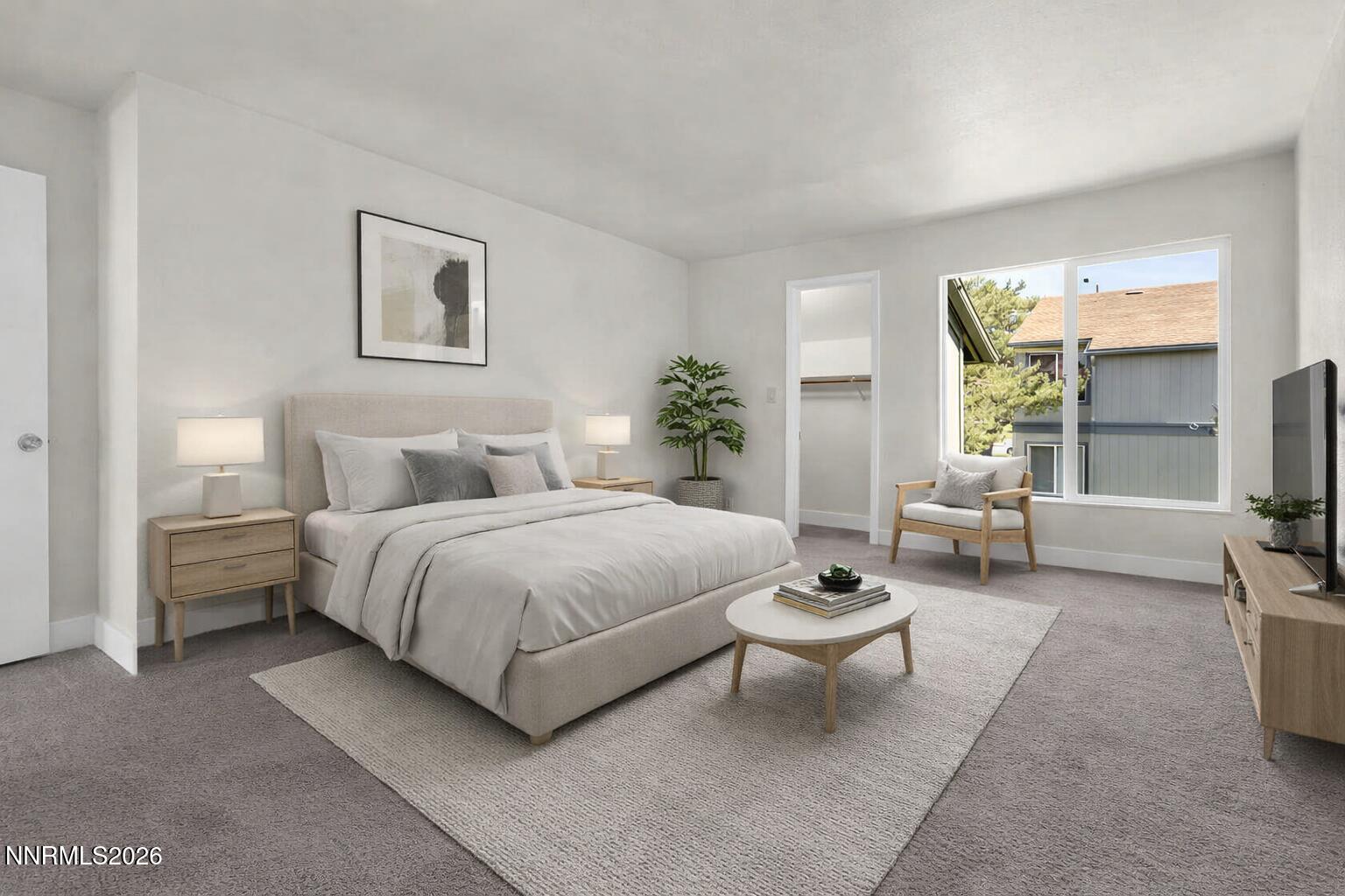 3905 Clear Acre Lane, Unit 26 Reno, NV 89512 - Photo 16 of 27 a spacious bedroom with a bed and table