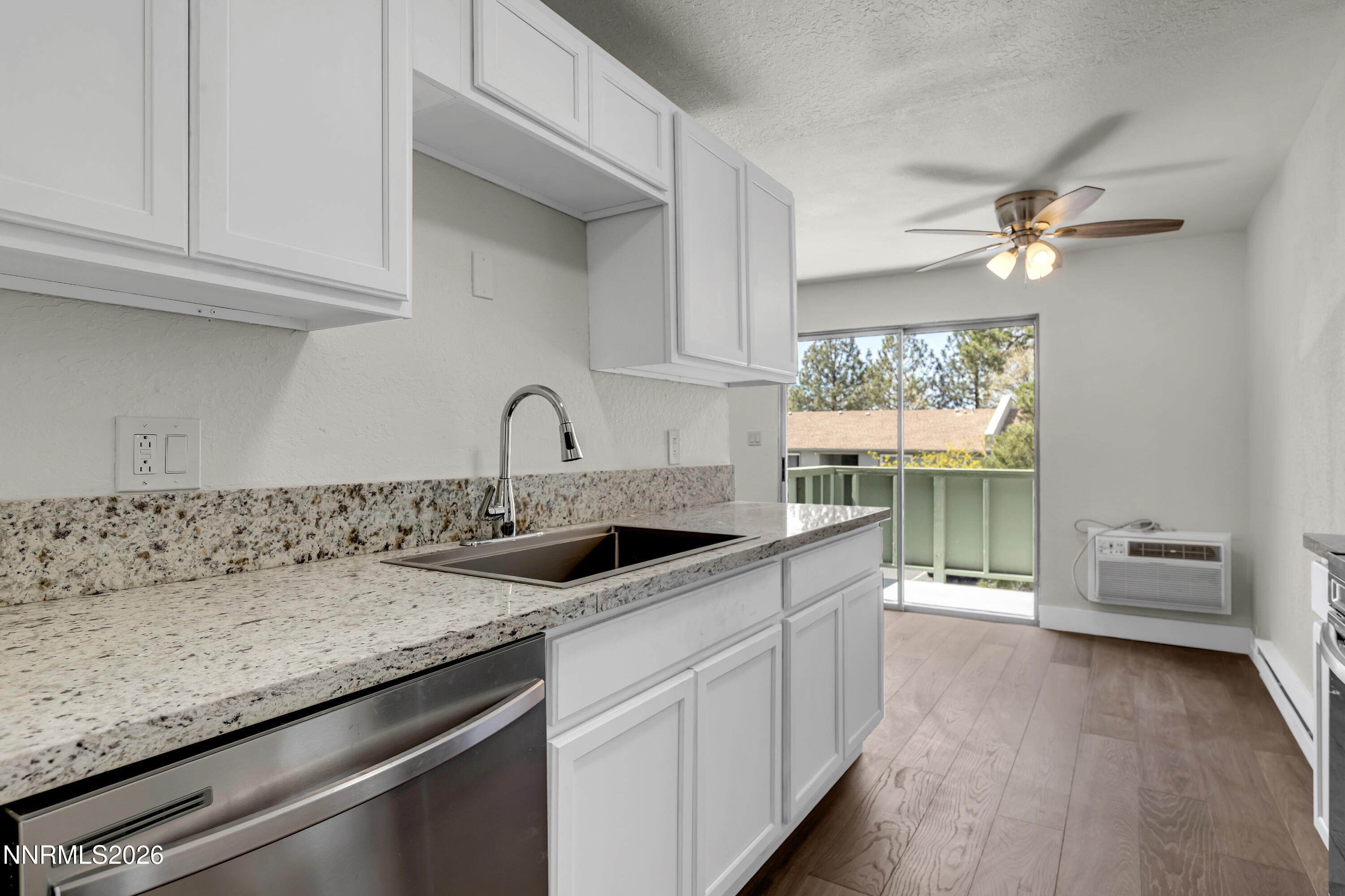 3905 Clear Acre Lane, Unit 26 Reno, NV 89512 - Photo 5 of 27 a kitchen with a sink cabinets and window