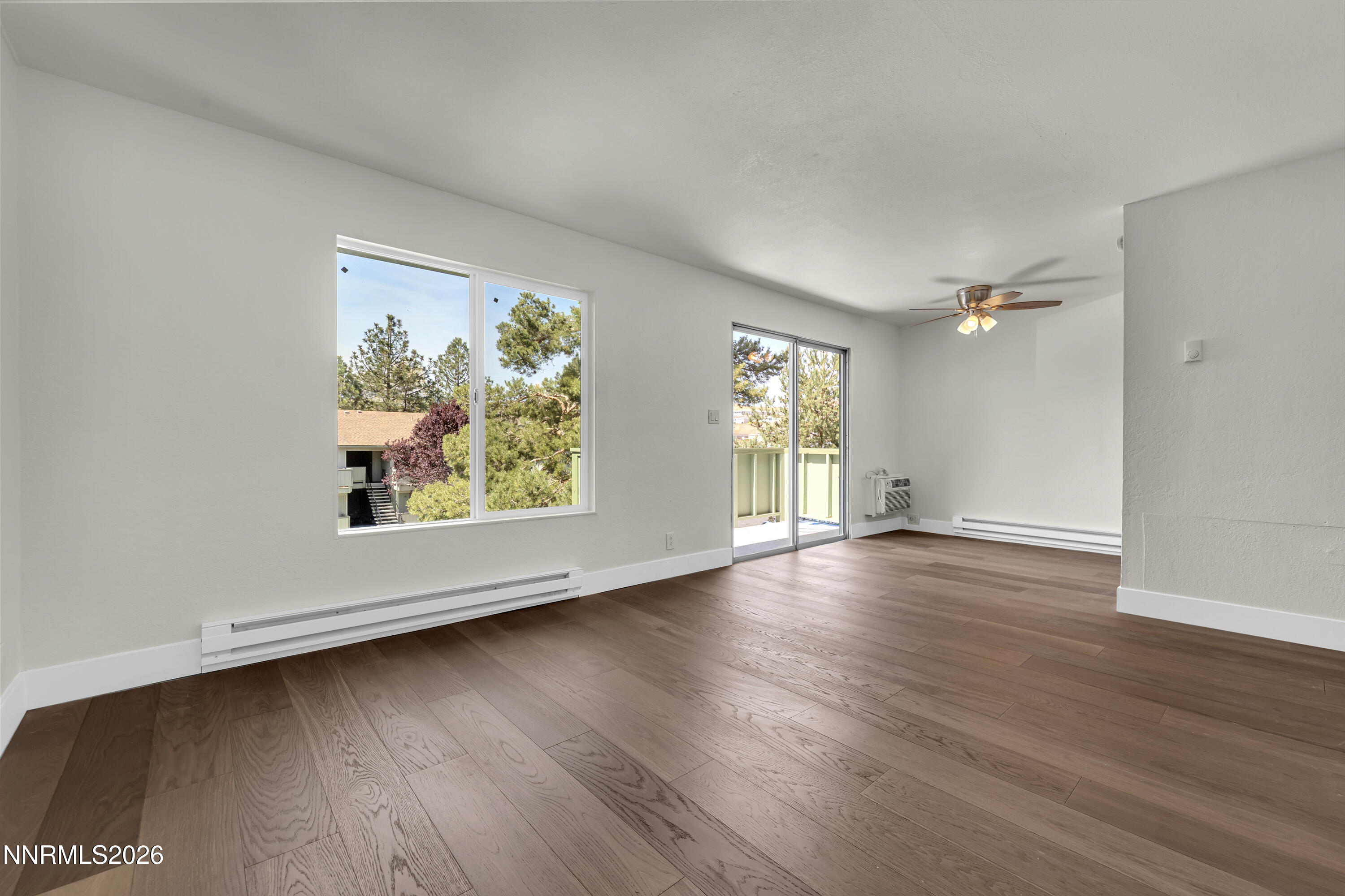 3905 Clear Acre Lane, Unit 26 Reno, NV 89512 - Photo 9 of 27 an empty room with wooden floor and windows