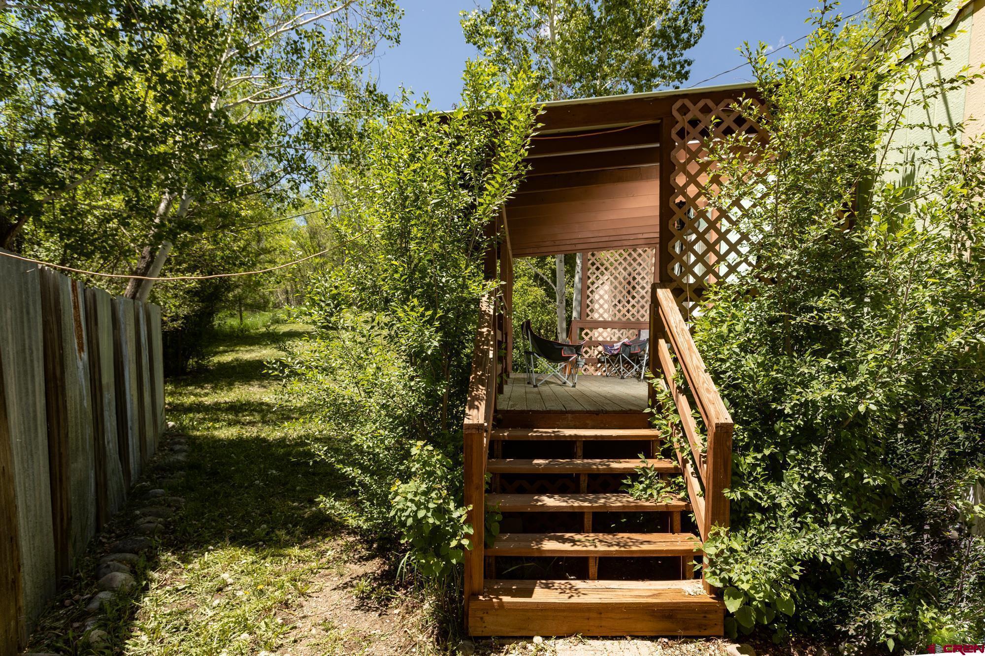 875 Browning Avenue Ignacio, CO 81137 - Photo 21 of 24 a view of stairs with wooden wall and plants