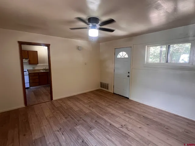 wooden floor in an empty room with a window