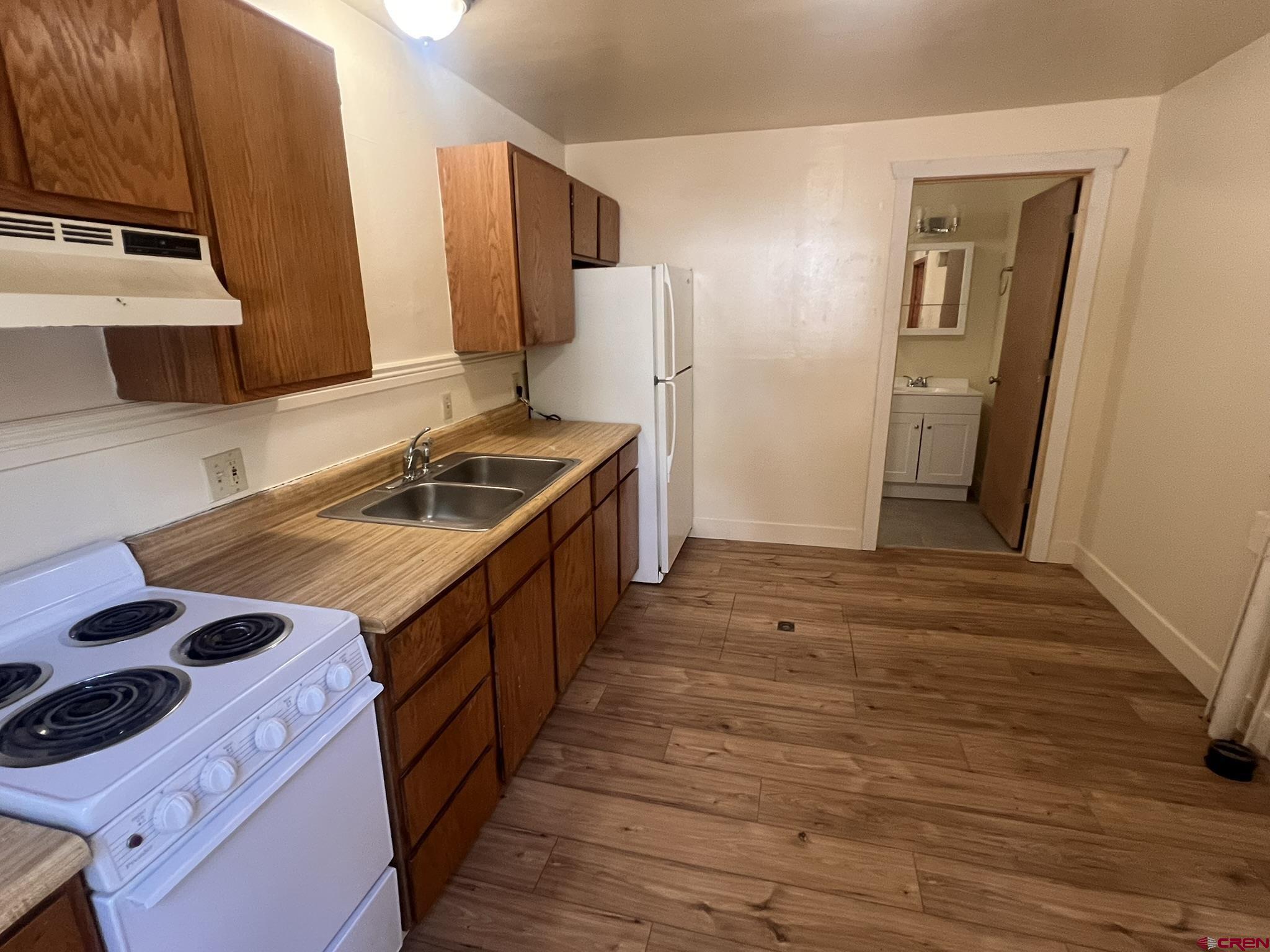 875 Browning Avenue Ignacio, CO 81137 - Photo 5 of 24 a kitchen with granite countertop a sink and a stove top oven
