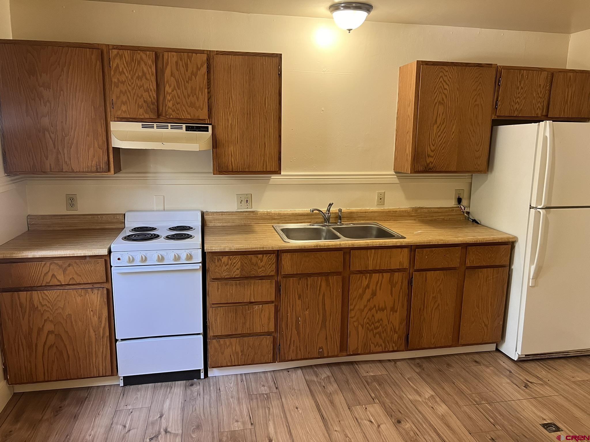 875 Browning Avenue Ignacio, CO 81137 - Photo 6 of 24 a kitchen with a sink cabinets and wooden floor