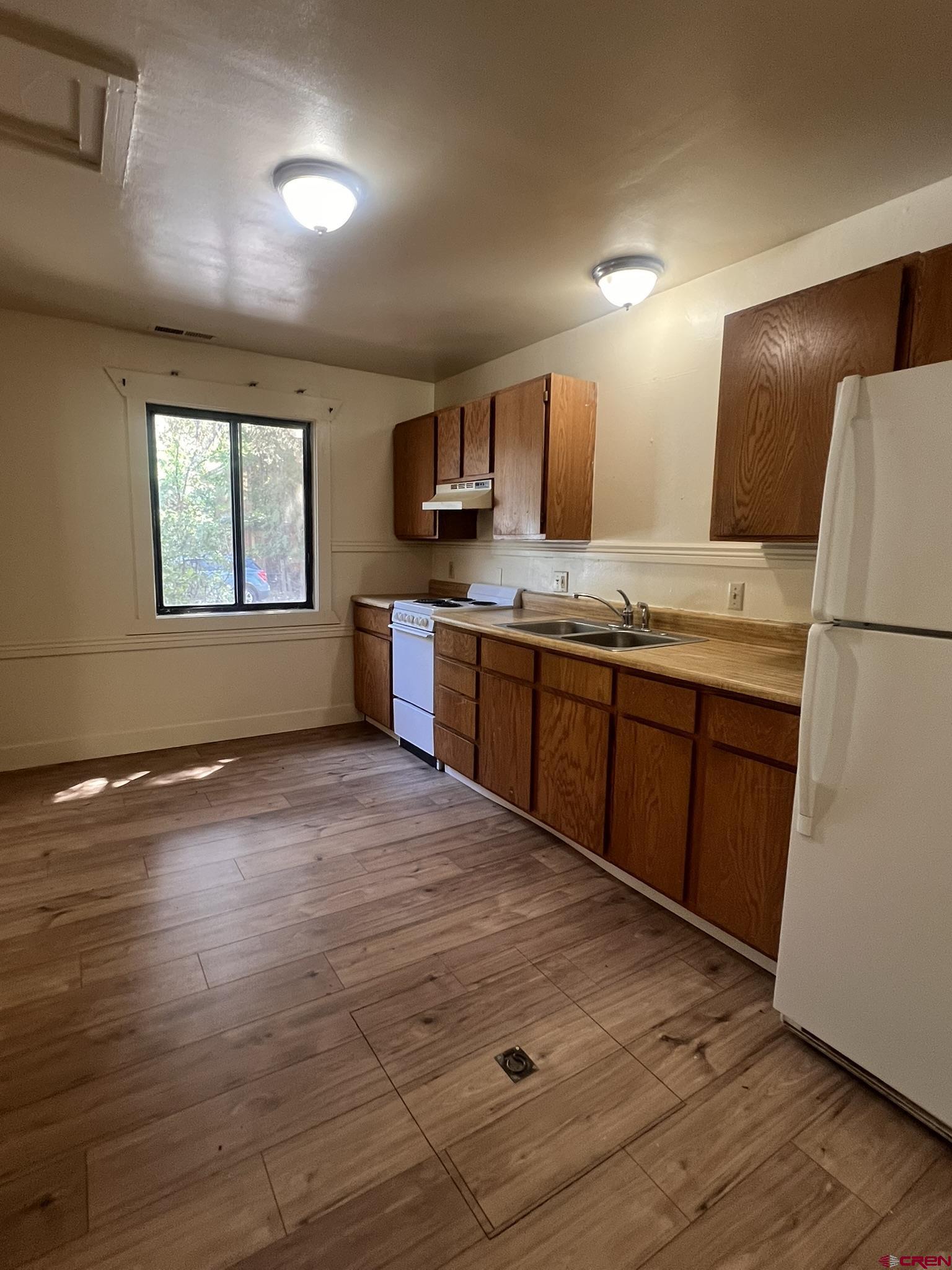 875 Browning Avenue Ignacio, CO 81137 - Photo 7 of 24 a large kitchen with stainless steel appliances granite countertop a sink and wooden cabinets