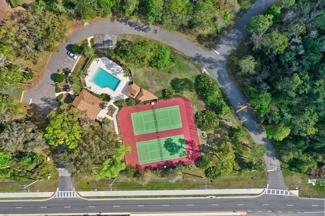 a view of a house with swimming pool and sitting area