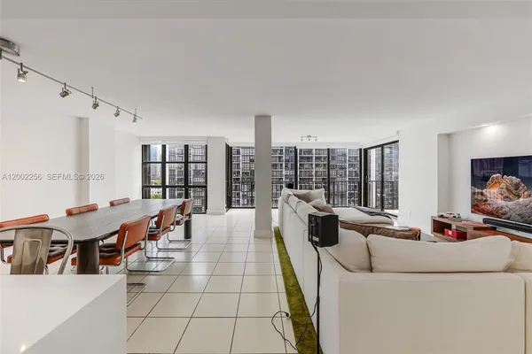 a living room with furniture and large windows