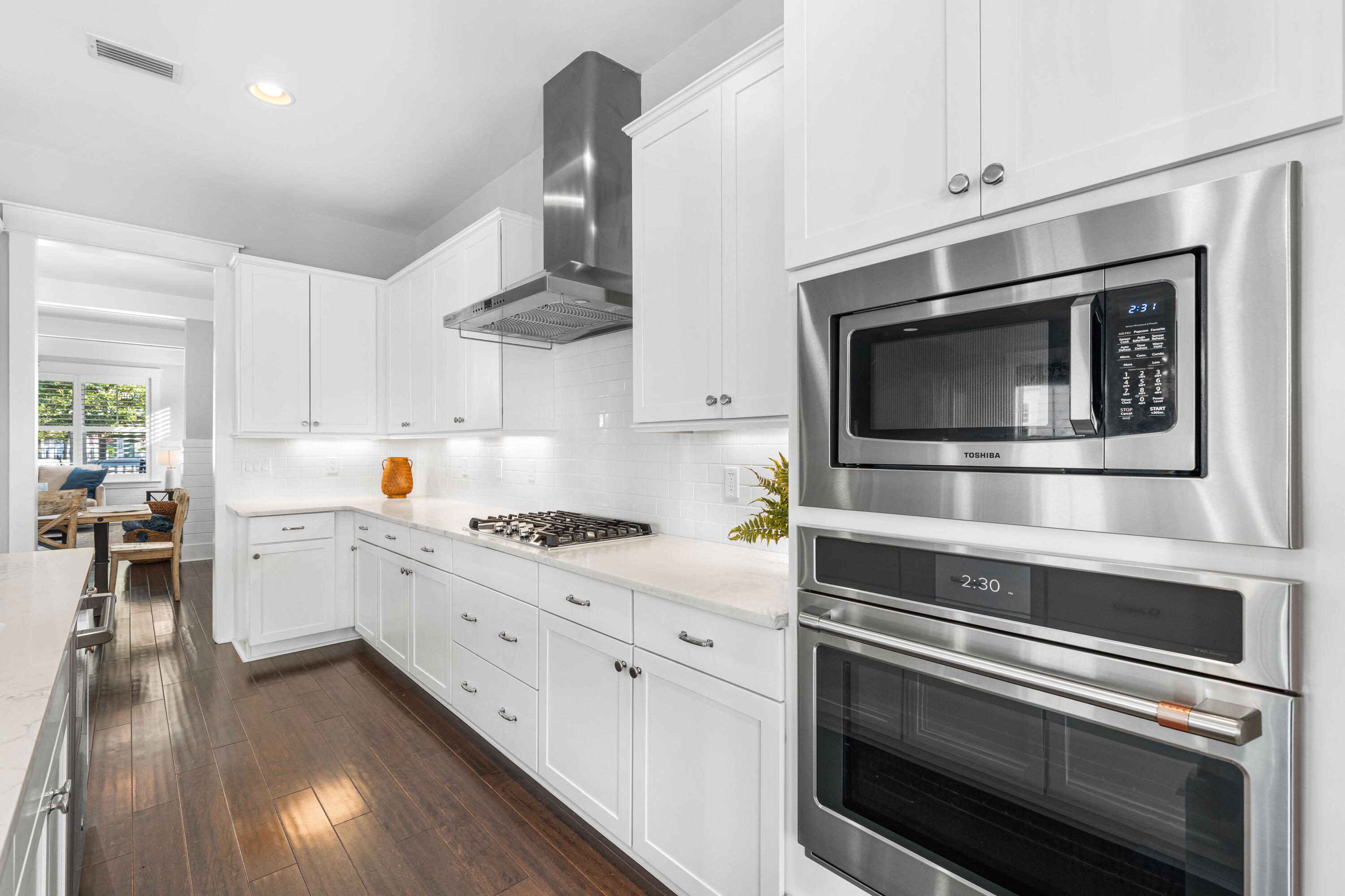 1085 Sandgrass Boulevard Santa Rosa Beach, FL 32459 - Photo 18 of 62 a kitchen with stainless steel appliances and white cabinets
