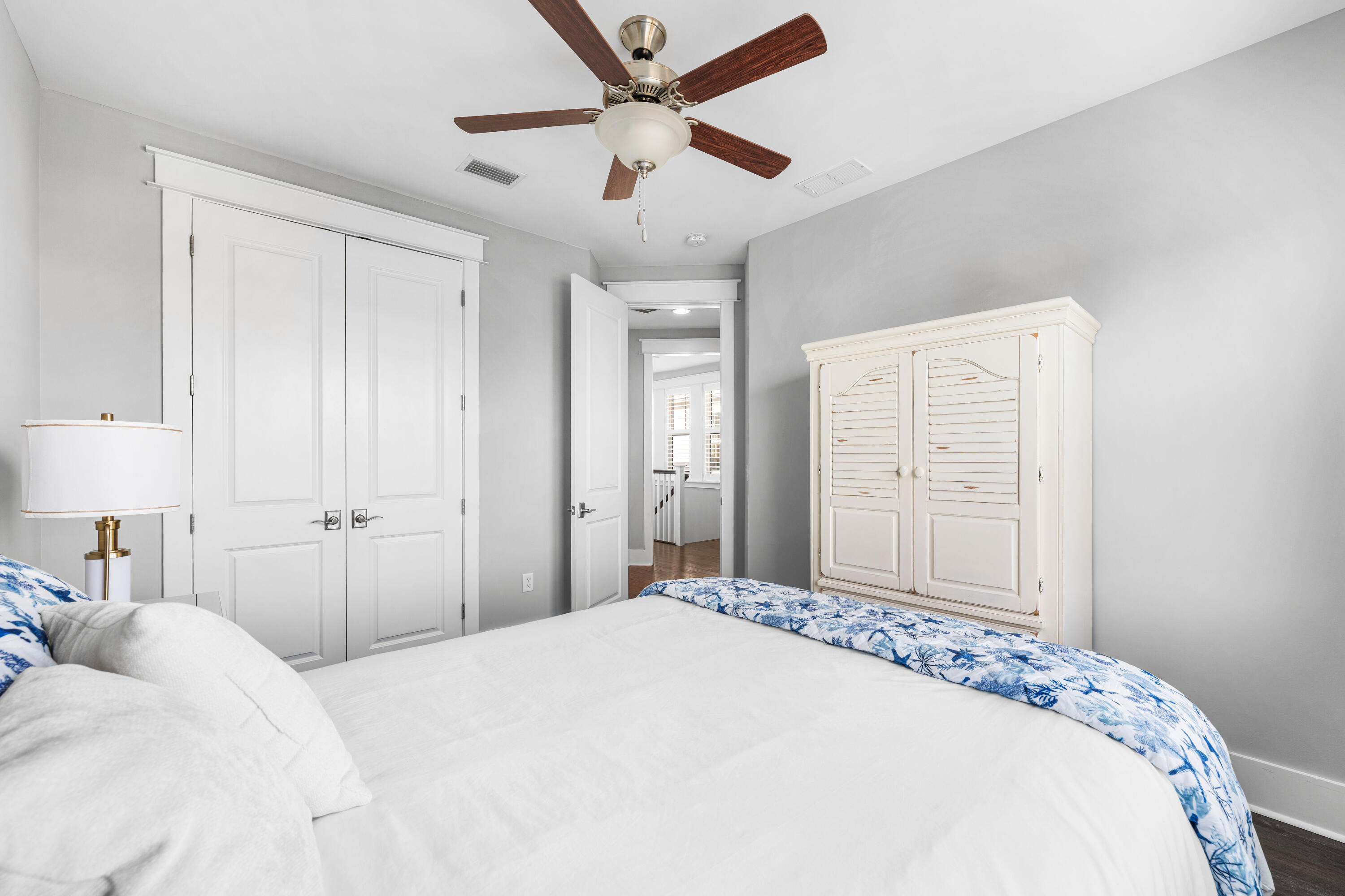 1085 Sandgrass Boulevard Santa Rosa Beach, FL 32459 - Photo 34 of 62 a bedroom with a large bed and a chandelier