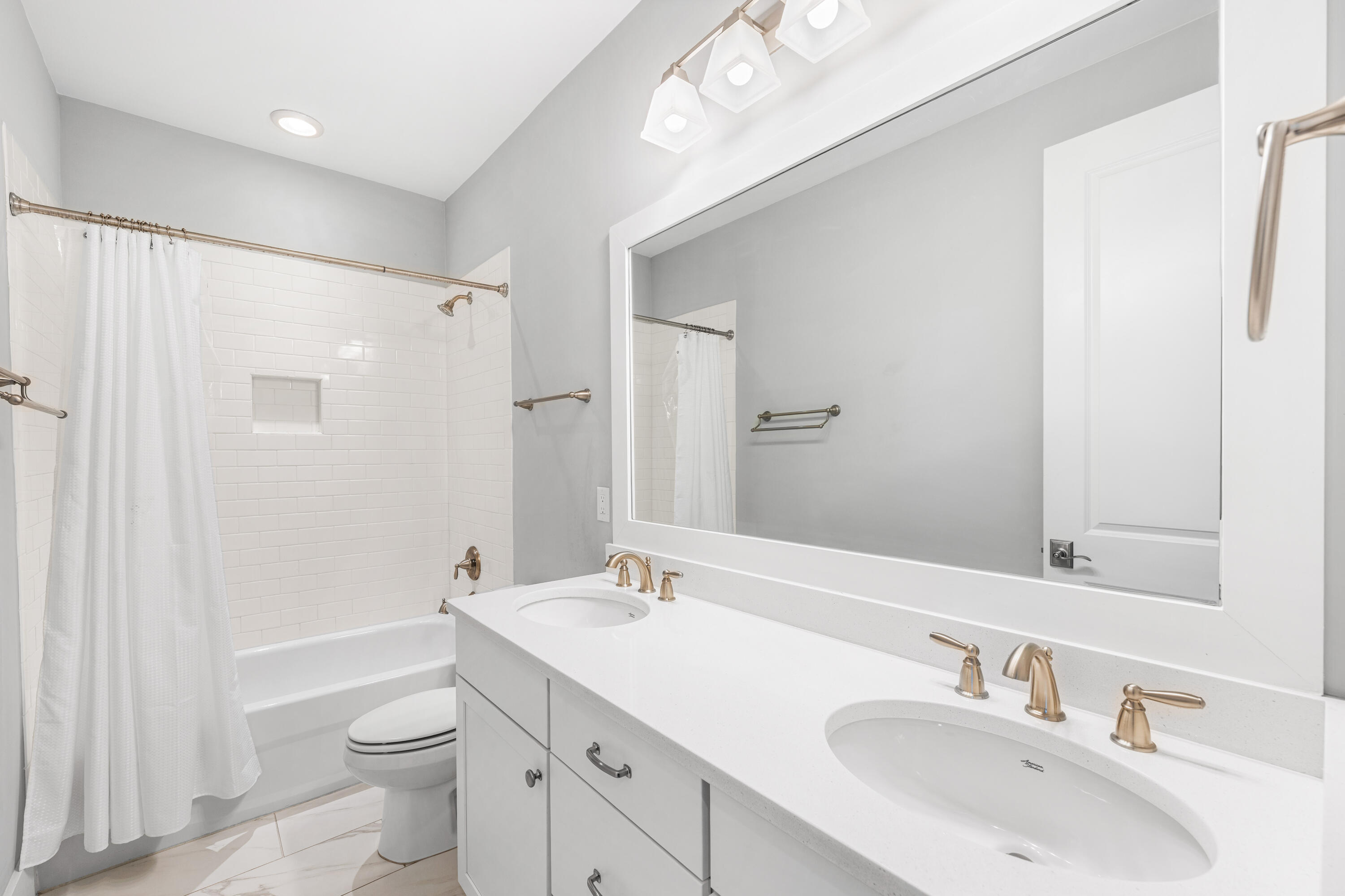 1085 Sandgrass Boulevard Santa Rosa Beach, FL 32459 - Photo 36 of 62 a bathroom with a sink a toilet a large mirror and shower