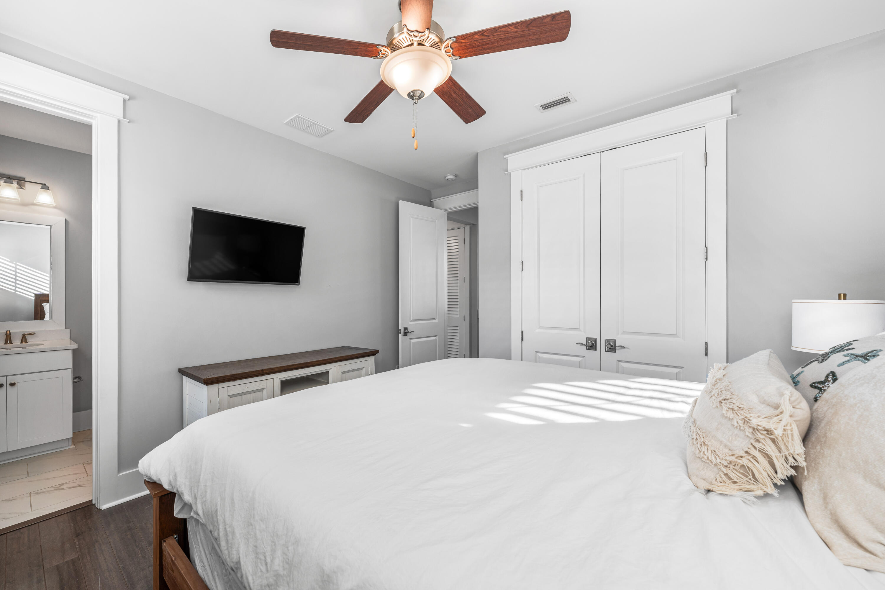 1085 Sandgrass Boulevard Santa Rosa Beach, FL 32459 - Photo 38 of 62 a bedroom with a bed and a flat tv screen on dresser