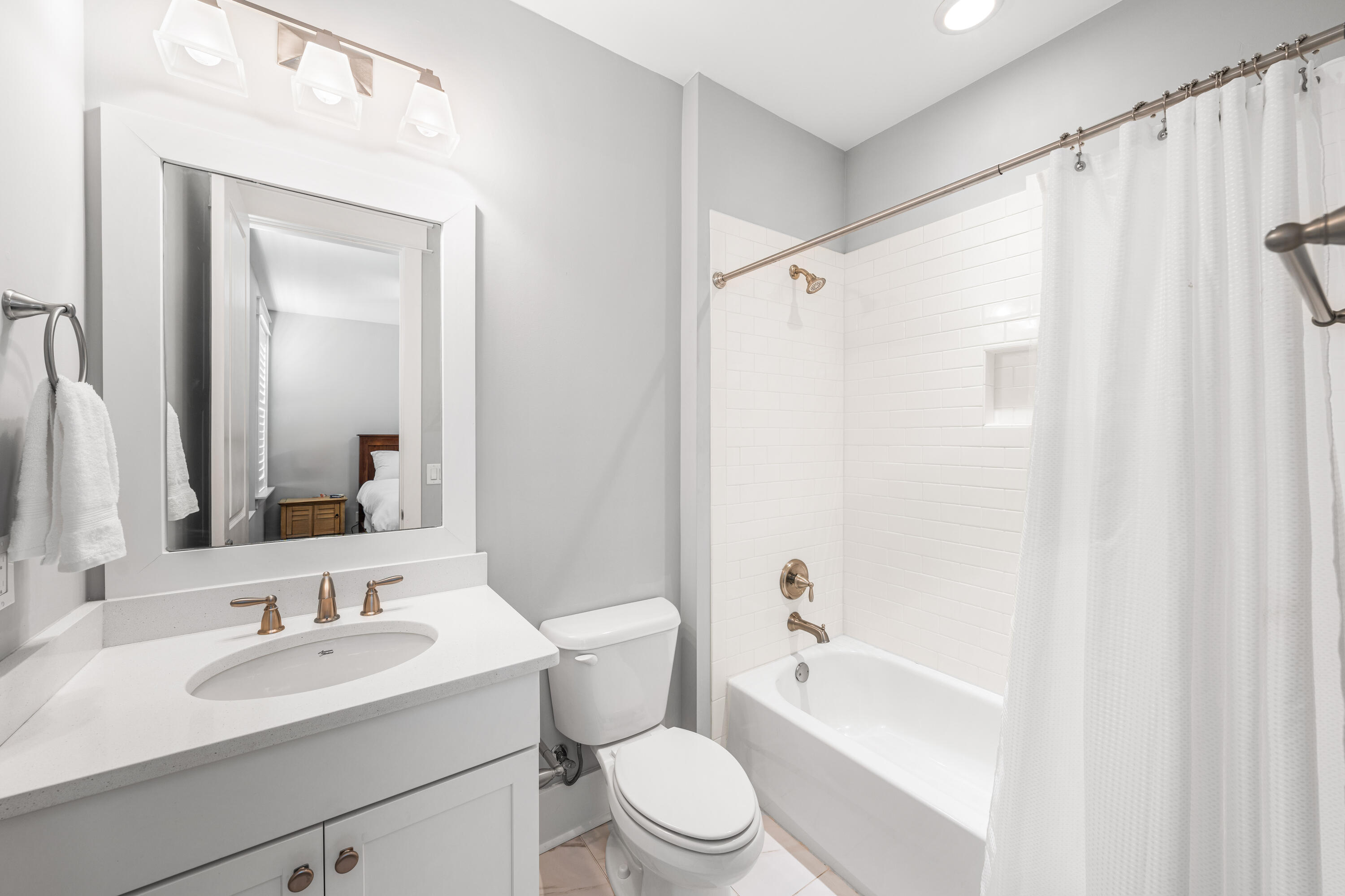 1085 Sandgrass Boulevard Santa Rosa Beach, FL 32459 - Photo 39 of 62 a bathroom with a sink a toilet a mirror a bathtub and shower