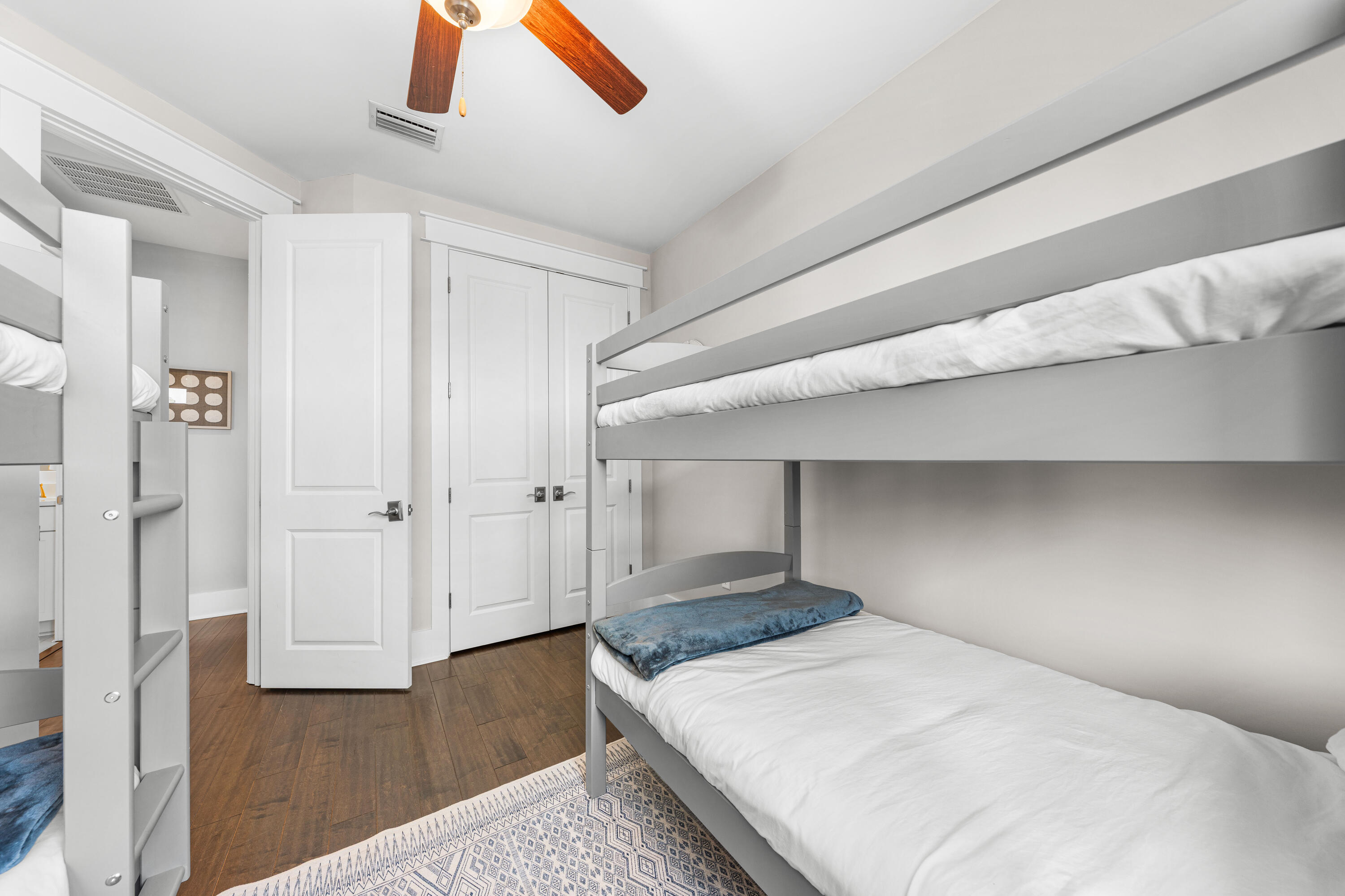 1085 Sandgrass Boulevard Santa Rosa Beach, FL 32459 - Photo 42 of 62 a bedroom with a bed and a ceiling fan