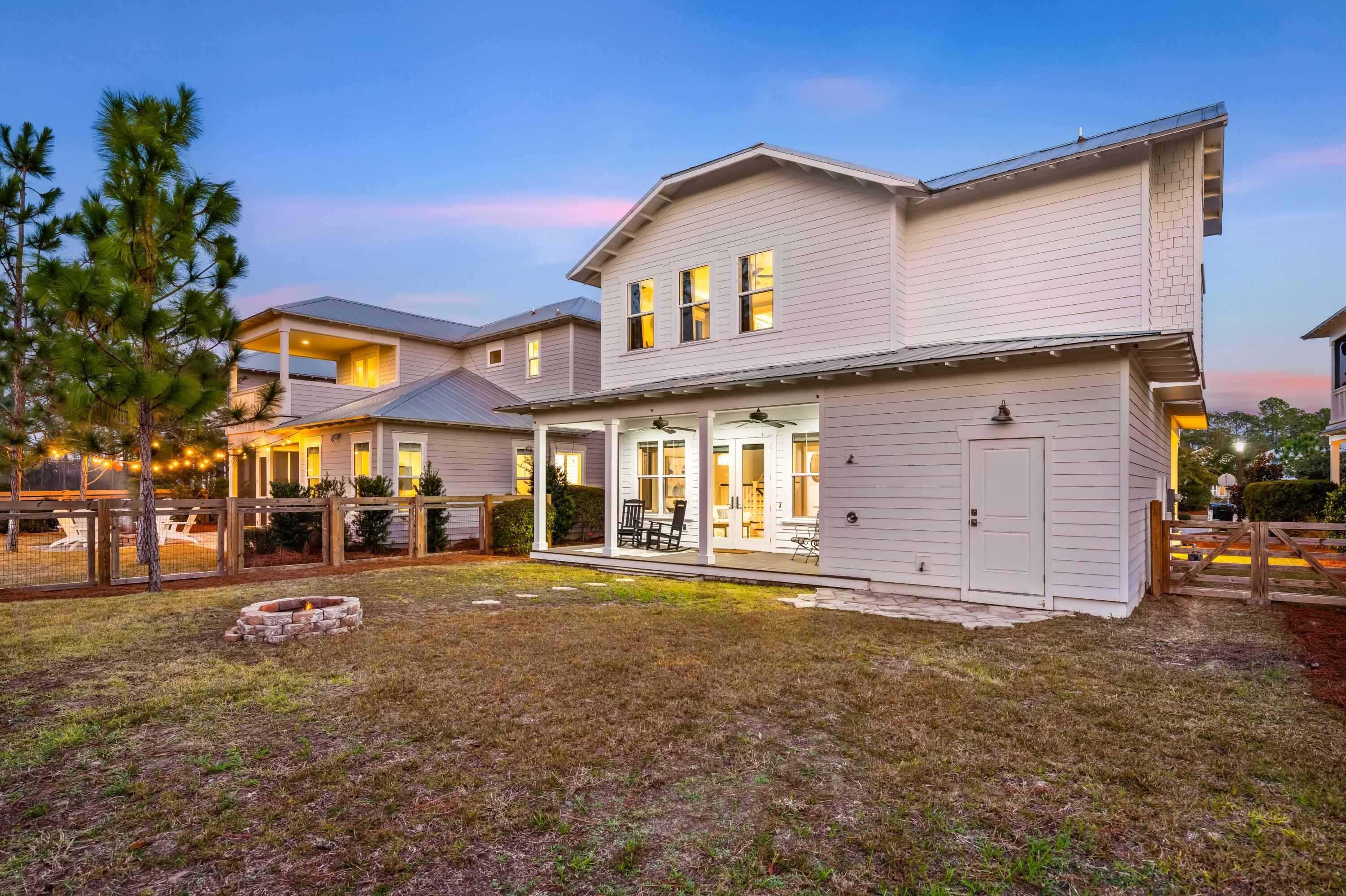 1085 Sandgrass Boulevard Santa Rosa Beach, FL 32459 - Photo 44 of 62 a front view of a building with a garden and plants