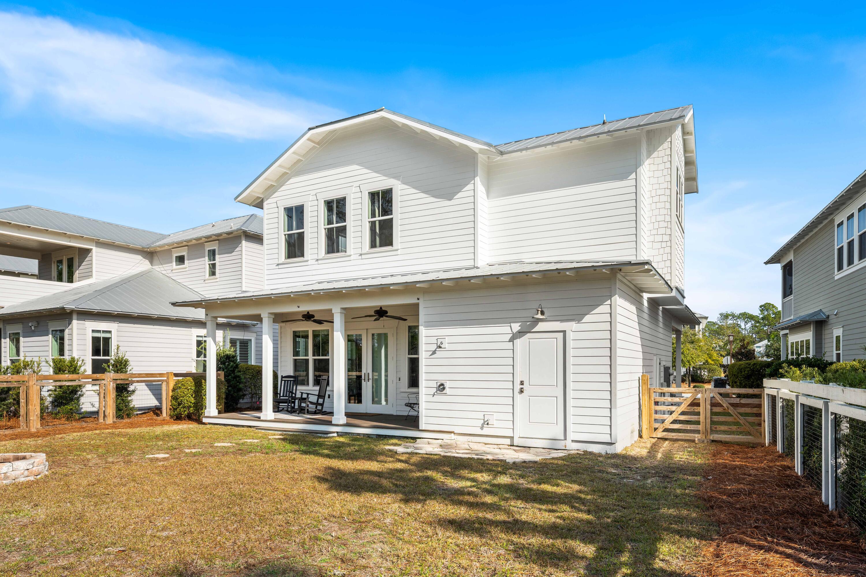 1085 Sandgrass Boulevard Santa Rosa Beach, FL 32459 - Photo 47 of 62 a view of a white house with a large windows