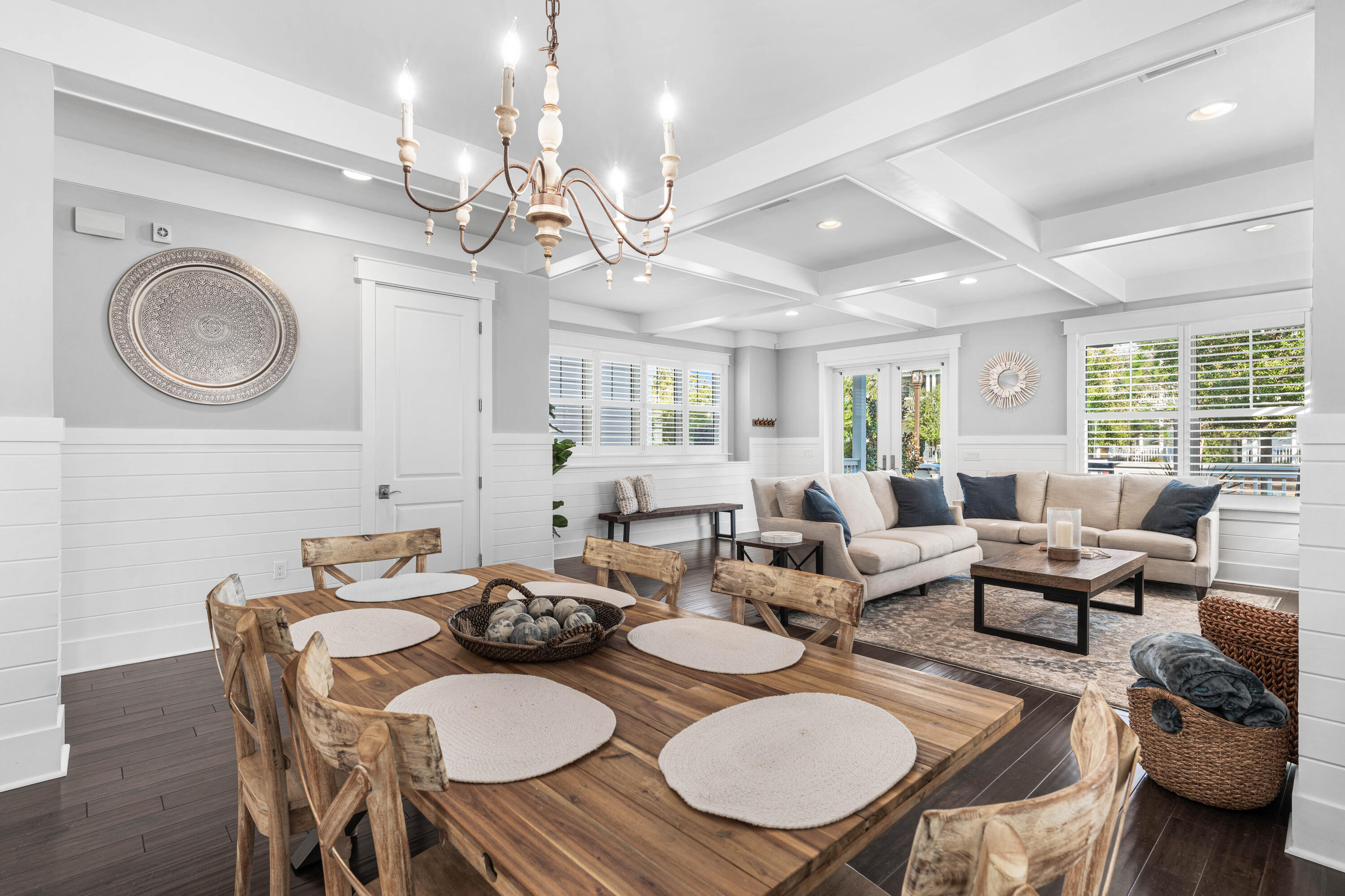 1085 Sandgrass Boulevard Santa Rosa Beach, FL 32459 - Photo 48 of 62 a living room with furniture a chandelier and a dining table