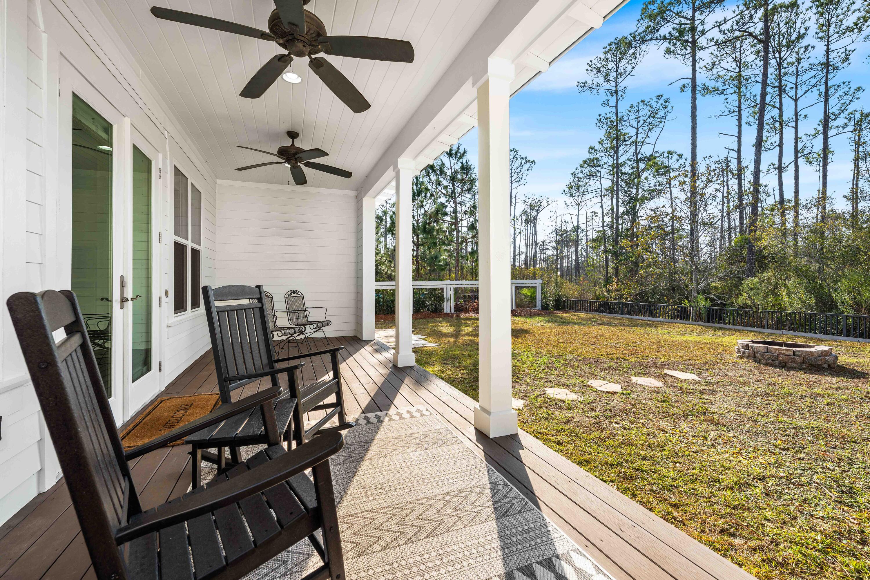 1085 Sandgrass Boulevard Santa Rosa Beach, FL 32459 - Photo 49 of 62 a view of a balcony with chairs and wooden floor