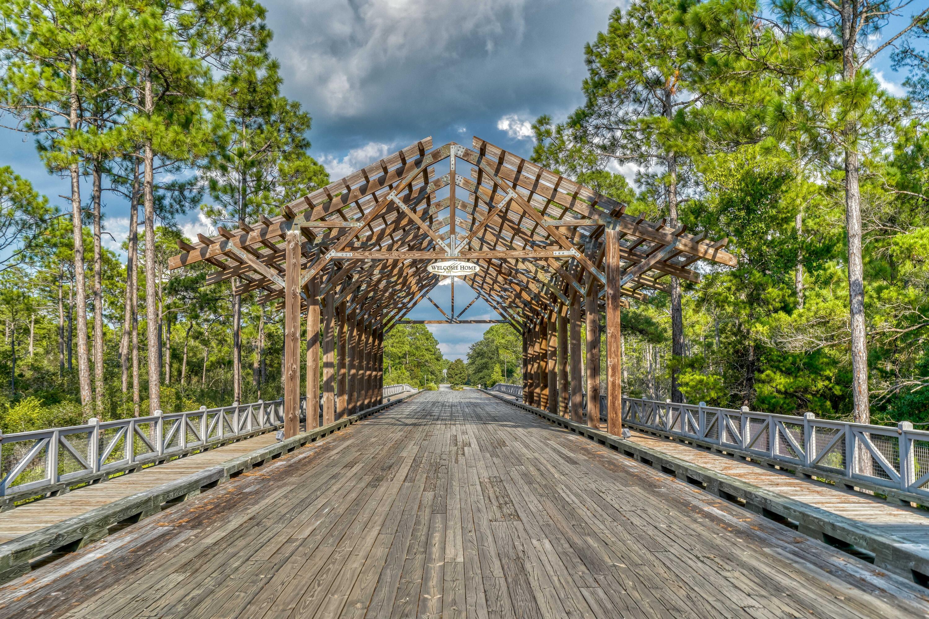 1085 Sandgrass Boulevard Santa Rosa Beach, FL 32459 - Photo 55 of 62 a view of a pathway with a wrought fence