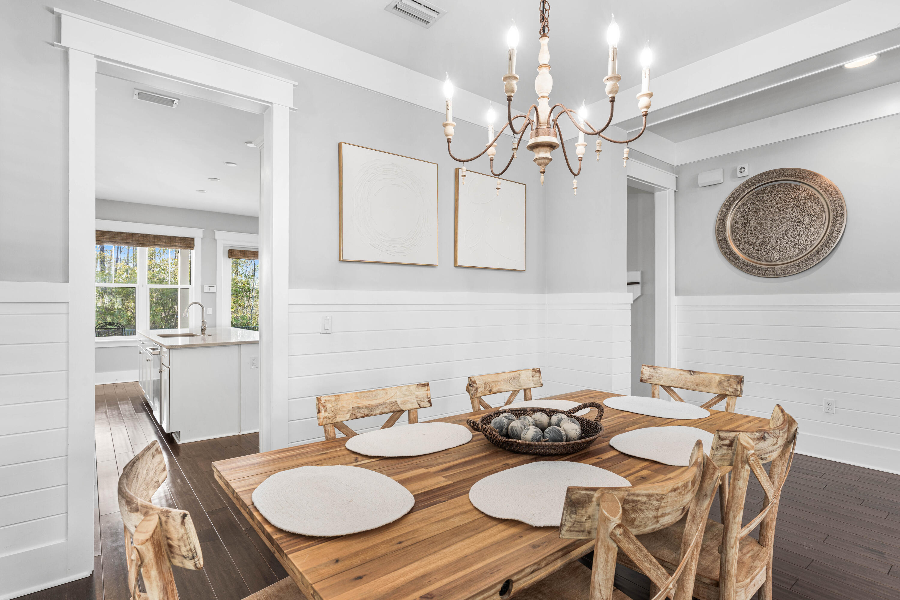 1085 Sandgrass Boulevard Santa Rosa Beach, FL 32459 - Photo 10 of 62 a view of a dining room with furniture a chandelier and wooden floor