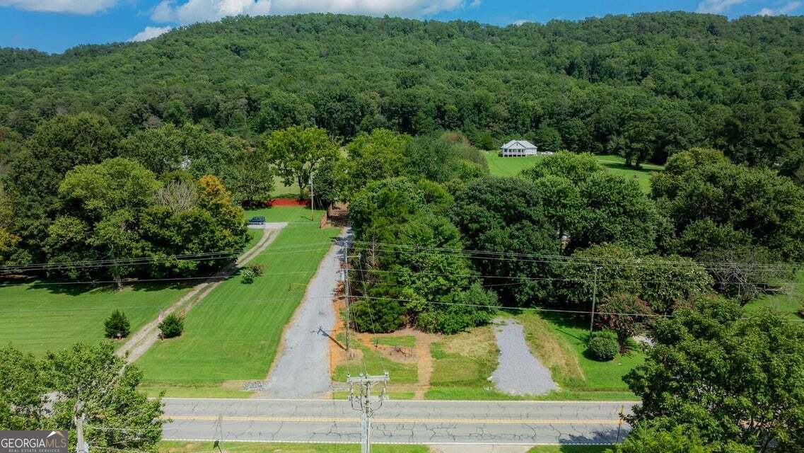 an aerial view of a houses with a yard