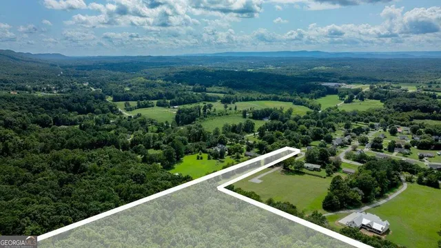 a view of a yard with wooden fence