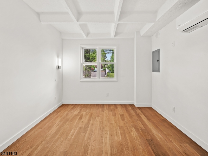 100 Chestnut Street, Unit 3 West Orange, NJ 07052 - Photo 16 of 18 an empty room with wooden floor and windows