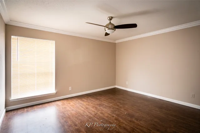 a view of a livingroom with a ceiling fan and window