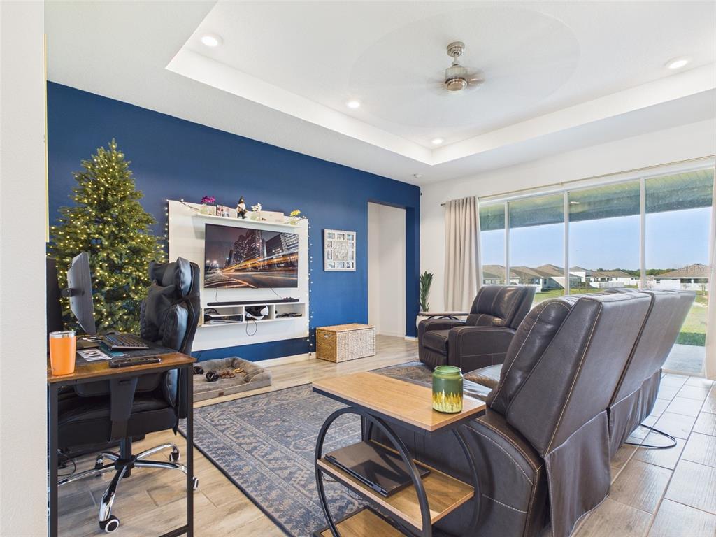 6224 Southwest 74th Ter Road Ocala, FL 34474 - Photo 12 of 52 a living room with furniture and a flat screen tv