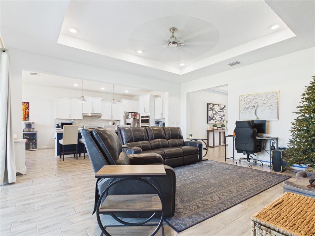 6224 Southwest 74th Ter Road Ocala, FL 34474 - Photo 14 of 52 a living room with furniture and a flat screen tv