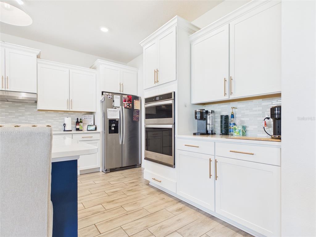 6224 Southwest 74th Ter Road Ocala, FL 34474 - Photo 16 of 52 a kitchen with stainless steel appliances a refrigerator sink and cabinets