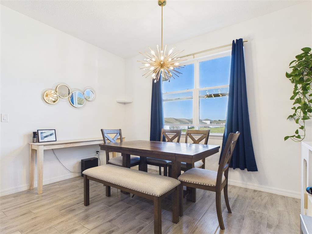 6224 Southwest 74th Ter Road Ocala, FL 34474 - Photo 23 of 52 a view of a dining room with furniture window and wooden floor