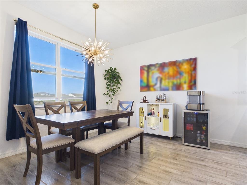 6224 Southwest 74th Ter Road Ocala, FL 34474 - Photo 24 of 52 a view of a dining room with furniture a chandelier and wooden floor