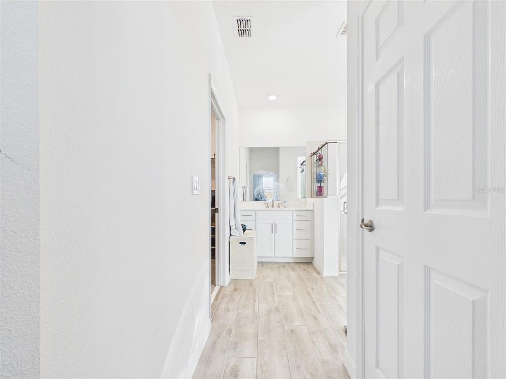 6224 Southwest 74th Ter Road Ocala, FL 34474 - Photo 31 of 52 a view of a kitchen with white cabinets and wooden floor