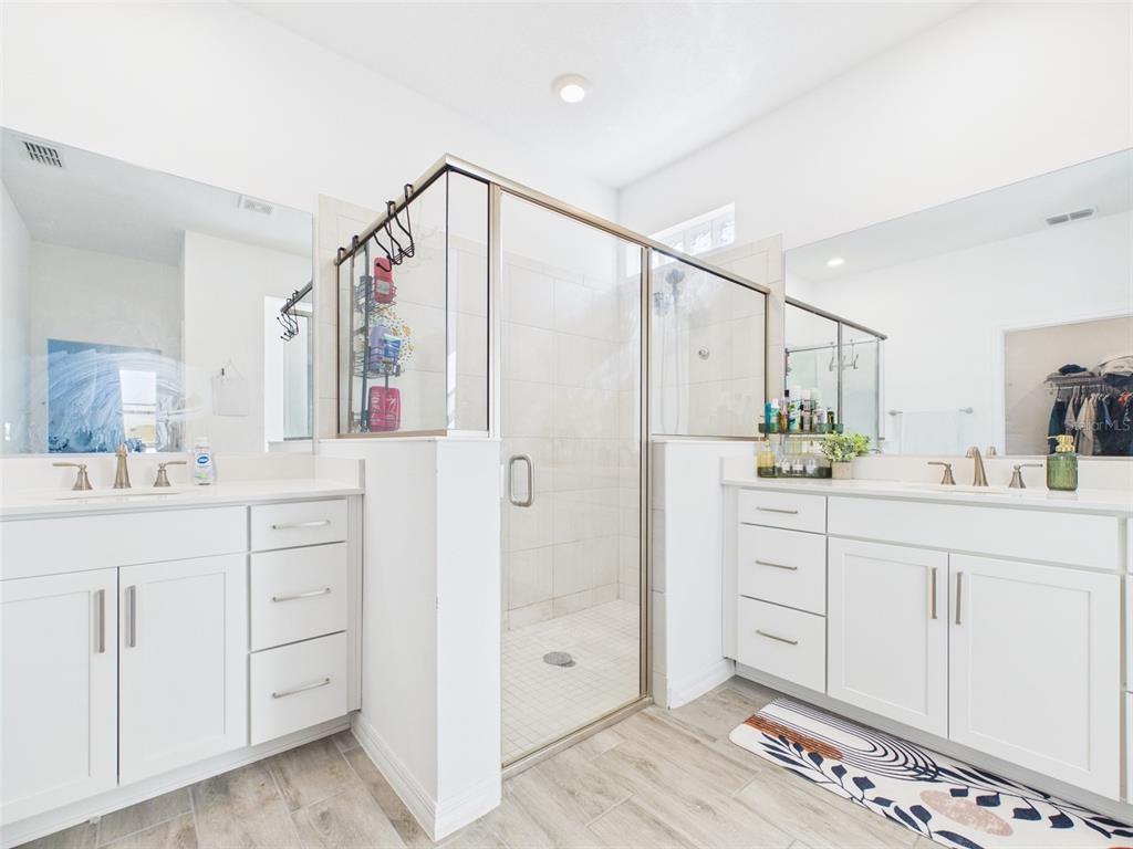 6224 Southwest 74th Ter Road Ocala, FL 34474 - Photo 33 of 52 a bathroom with a shower sink and mirror