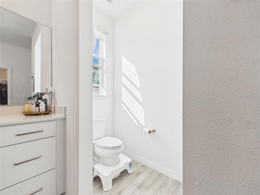 6224 Southwest 74th Ter Road Ocala, FL 34474 - Photo 34 of 52 a bathroom with a sink a toilet and a mirror