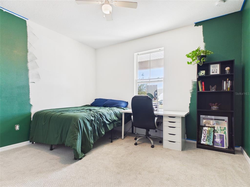 6224 Southwest 74th Ter Road Ocala, FL 34474 - Photo 39 of 52 a bedroom with a bed and a chair