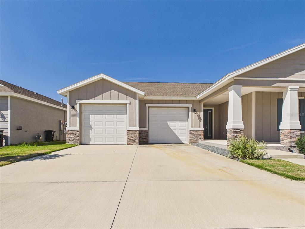6224 Southwest 74th Ter Road Ocala, FL 34474 - Photo 5 of 52 a front view of a house with a yard and garage